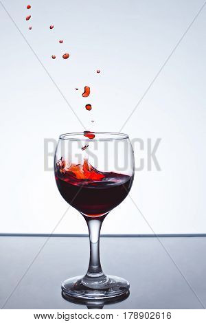Red wine splash over white background on a white background freezing