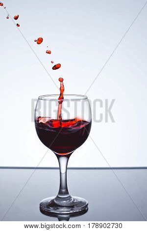 moving red wine glass over a white background on a white background freezing