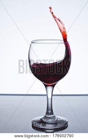 moving red wine glass over a white background on a white background freezing
