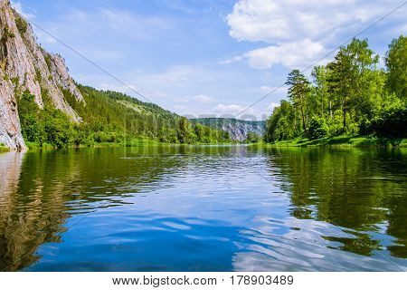 landscape with mountains, forest and a river in front. beautiful scenery