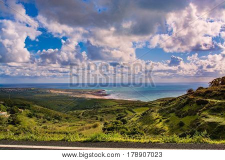 Sintra Portugal. 25 March 2017.View of Guincho beach and green fields sourouding from the road to Cabo da Roca in Sintra Portugal. Sintra Portugal. photography by Ricardo Rocha.