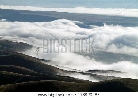 Clouds Covering a Mountain Valley with Rolling Hills at Sunrise