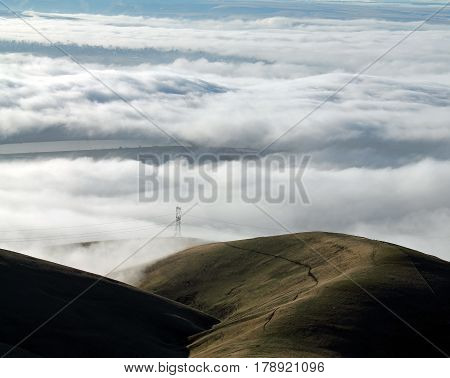 Clouds Covering a Mountain Valley with Rolling Hills at Sunrise