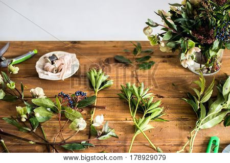 Table of florist. Florist workspace. Scissors, skein harness. Old wooden table. The working surface. Make a bouquet. Hobbies, business occupation