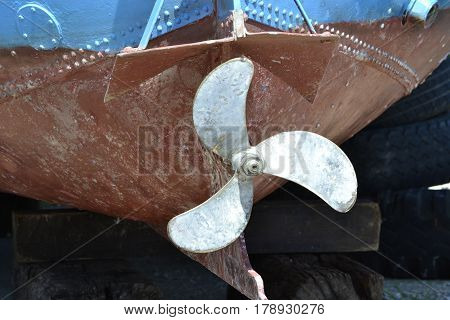 propellers at the stern of the old metal boat