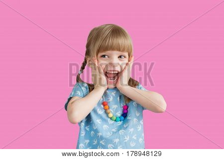Little girl smiling at the background in the studio