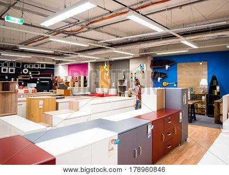 BUCHAREST ROMANIA - APR 1 2016: Woman buying wardrobe cabinet storage and interior furniture at the KIKA store selling ready-to-assemble furniture kitchen appliances and home accessories