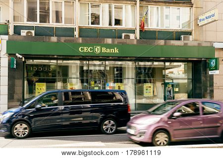 BUCHAREST ROMANIA - APR 1 2016: Cars driving fast on Bucharest boulevard with CEC bank agency in the background. CEC Bank is a state-owned Romanian banking institution
