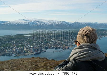 A beautiful girl looking at mountains inside artic circle
