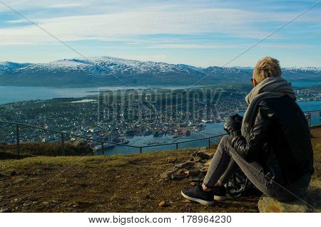 A beautiful girl looking at mountains inside artic circle