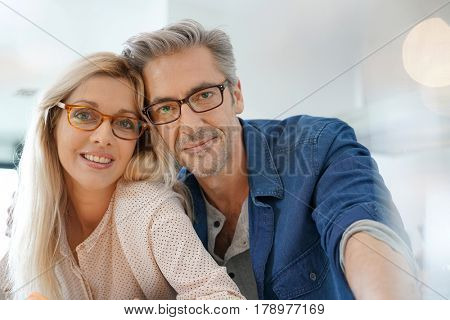 Portrait of happy middle-aged couple with eyeglasses