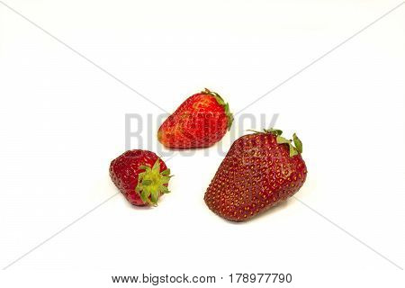 Red strawberries on a table on a white background