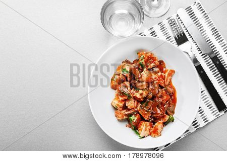 Plate with tasty chicken cacciatore on table