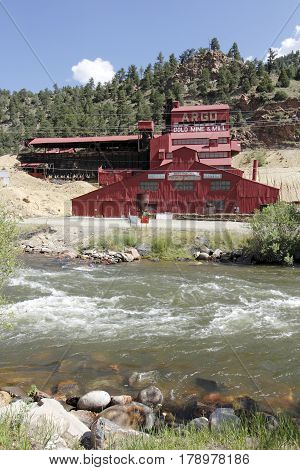 Idaho Springs CO USA - June 24 2016: A red painted historical gold mine mill and mining museum. The historical gold mine is a major attraction in Idaho Springs.
