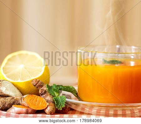 a cup of Turmeric Tea with lemon and ginger Benefits for reduce Inflammation Liver Detox and Cleanser healthy herb drink concept