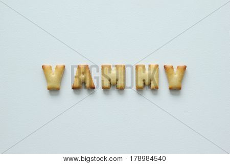 An Inscription From The Cookies On The White Background. Text – Yammy.