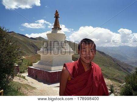Lhasa, Tibet, China - September 2011: Tibetan monk of Buddhist monastery Druk Yerpa near the ritual construction Stupa on September 2011 in Lhasa, Tibet, China.