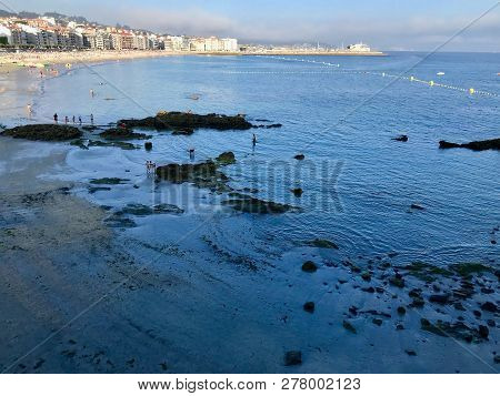 View Of A Typical Beach Day During A Sunny Summer In Sanxenxo Galicia Spain