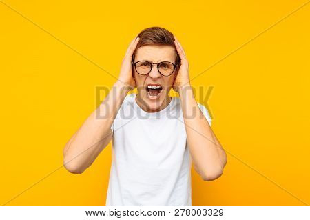 Irritated Man In Glasses, A Man Is Shouting Aggressively, On A Yellow Background