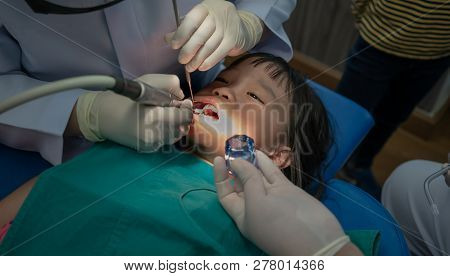 Asian Girl Met The Dentist For Routine Dental Checkup And Consult. Dental Cleaning Process.
