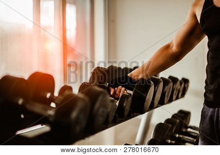 Rows Of Dumbbells In The Gym With Hign Contrast And Monochrome Color Tone.