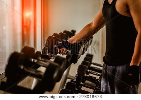 Rows Of Dumbbells In The Gym With Hign Contrast And Monochrome Color Tone.