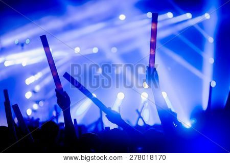 Silhouettes Of Hand In Concert.light From The Stage.