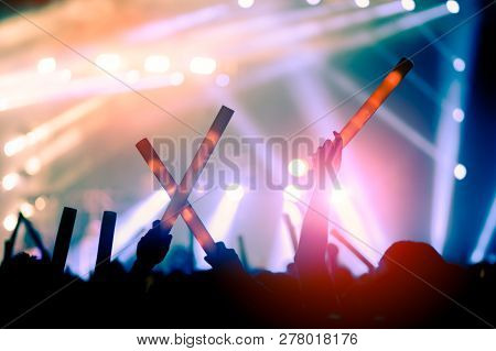 Silhouettes Of Hand In Concert.light From The Stage.