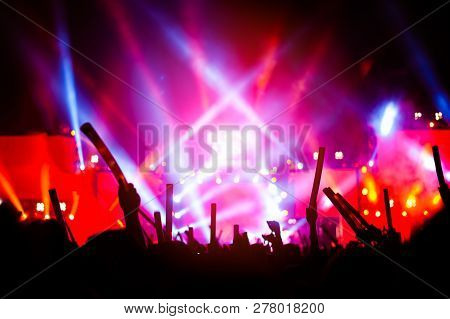 Silhouettes Of Hand In Concert.light From The Stage.