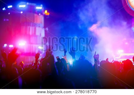 Silhouettes Of Hand In Concert.light From The Stage.