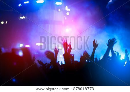Silhouettes Of Hand In Concert.light From The Stage.