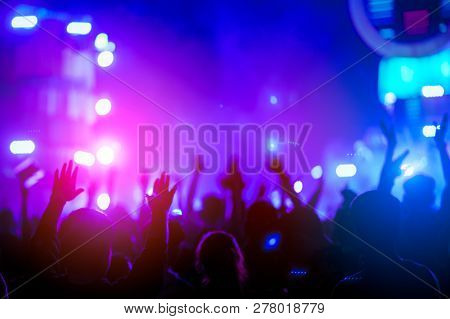 Silhouettes Of Hand In Concert.light From The Stage.