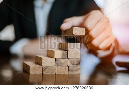 Plan And Strategy In Business.risk Concept.hand Of Man Has Piling Up And Stacking A Wooden Block.bus