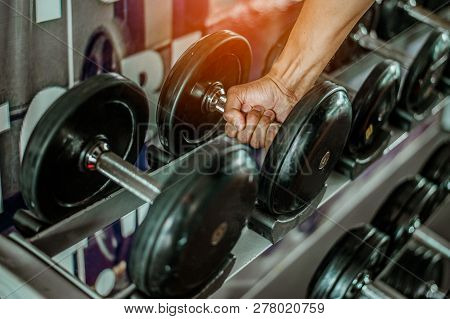 Rows Of Dumbbells In The Gym With Hign Contrast And Monochrome Color Tone.