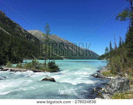 Beautiful Mountain River Flowing Into The Lake. Blue Kucherla River In Belukha National Park, Altai 