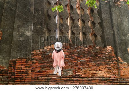 Female Tourist Looking At False Windows Of The Royal Vihara At Wat Mahathat Temple Within Ayutthaya 