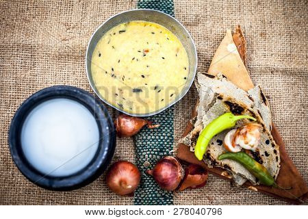 Close Up Of Poor Man's Complete Milk On Gunny Bag's Background With White Lentil,pearl Millet Roti O