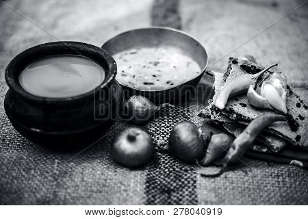 Close Up Of Poor Man's Complete Milk On Gunny Bag's Background With White Lentil,pearl Millet Roti O
