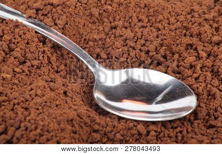 Many Of Milled Coffee And Teaspoon At Dry Sunny Summer Day