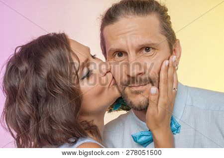 Wife Kisses Husband's Cheek, Wearing A Bow Tie