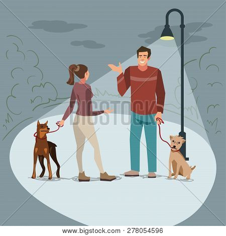 Young People (man And Woman) Walk In The Park With Their Dogs In The Evening When Lighted Lanterns. 