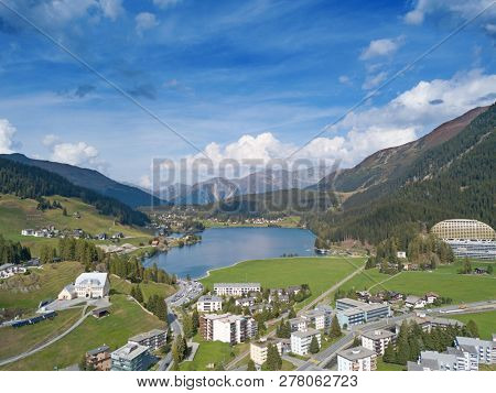 Aerial view of Davos city and lake. Davos is swiss city, famous location of annual meetings of World Economic Forum.
