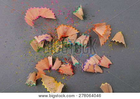 Pencil Shavings On Gray Paper. Different Colors.