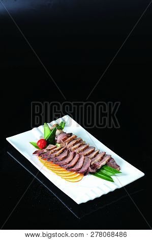 Sauce Char Siew Slices In A White Dish