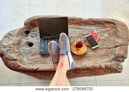Man With Coffee / Tea And Laptop On A Home Porch.