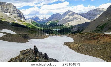 A Female Hiker Backcountry Hiking Through The Remote, Secluded, And Beautiful Rocky Mountains In Kan
