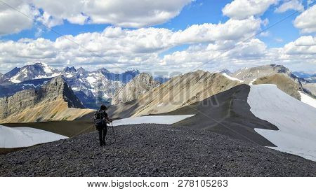 A Female Hiker Backcountry Hiking Through The Remote, Secluded, And Beautiful Rocky Mountains In Kan
