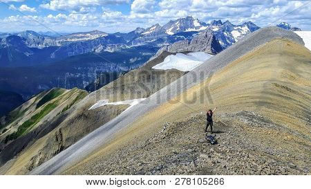 A Female Hiker Backcountry Hiking Through The Remote, Secluded, And Beautiful Rocky Mountains In Kan