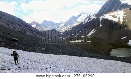 A Female Hiker Backcountry Hiking Through The Remote, Secluded, And Beautiful Rocky Mountains In Kan