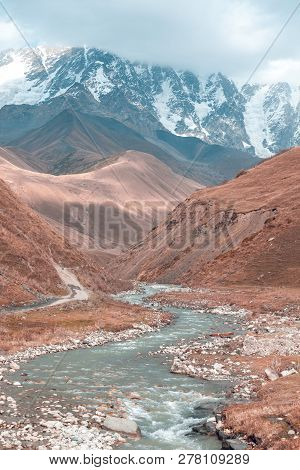 The Valley Of The Enguri River In Autumn. The Highest Peak Of Georgia Is Shkhara. Main Caucasian Rid